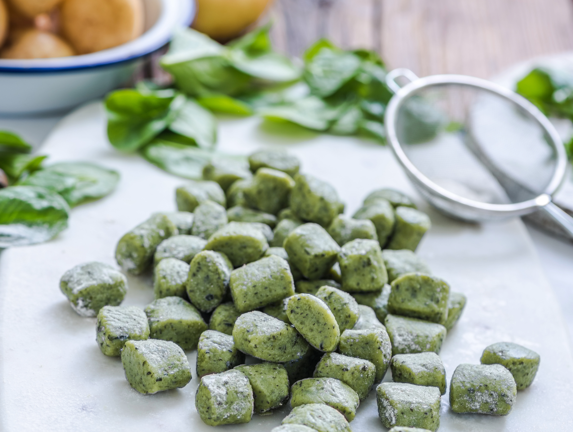 Spinach gnocchi, green potato dumplings dusted with flour