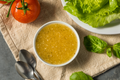 Bowl of Italian dressing with herb-speckled golden sauce