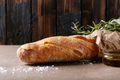 Rustic baguette loaf with golden-brown crust and flour dusting